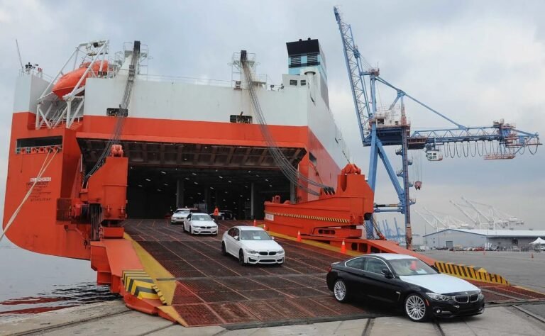 Car driving onto a RoRo ship ramp